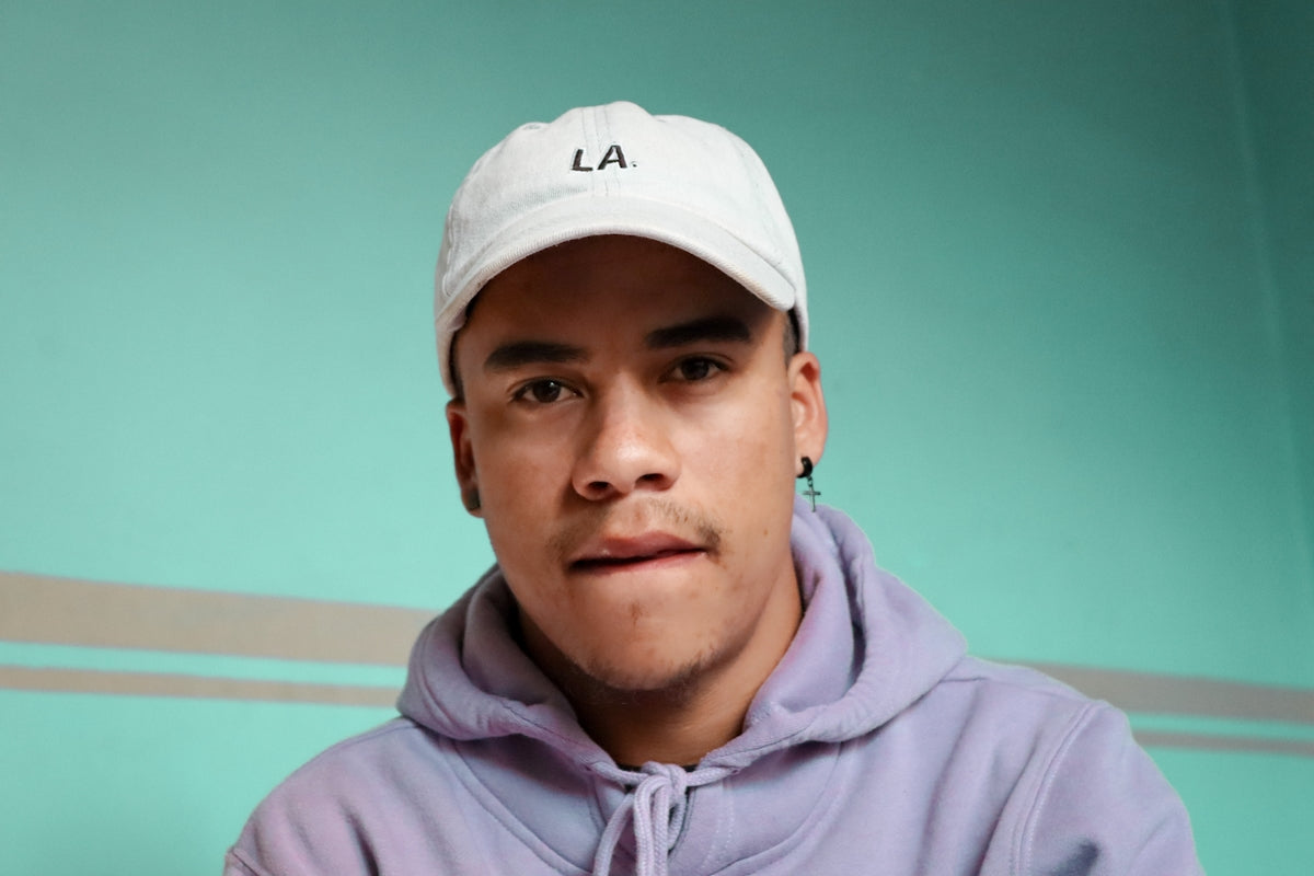 man in white nike cap and pink hoodie