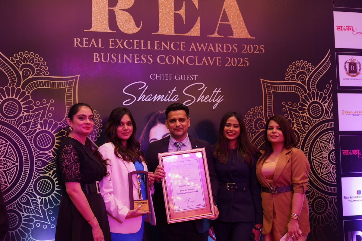 Group poses with award at real excellence awards 2025.